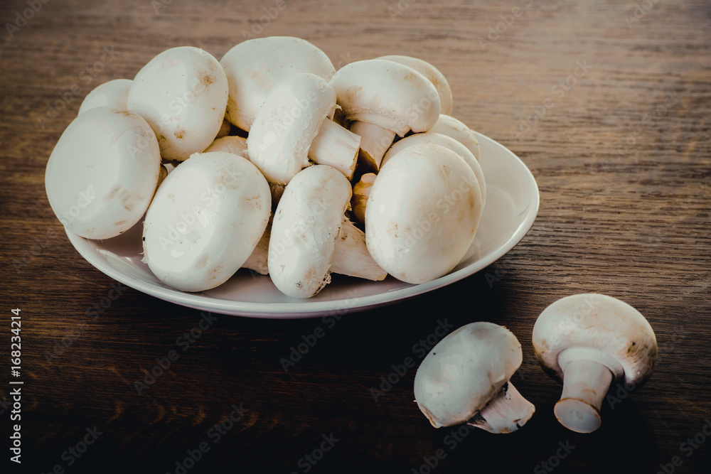 Fresh raw mashroom lying on a plate. Fresh raw mashroom lying on a plate.
