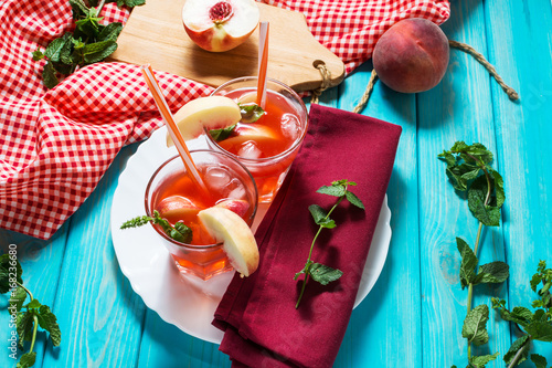 Homemade lemonade with ripe peaches and fresh mint