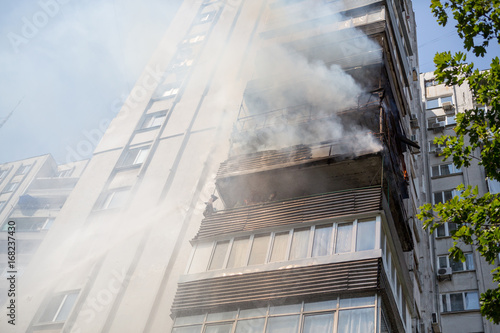 High-rise condominium or apartment burning. Fire in apartments of a large tenement-house.