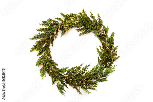 Christmas round frame made of winter evergreen plants. Flat lay.