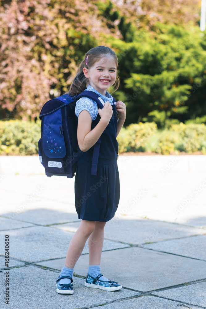 Beautiful smiling school girl with backpack