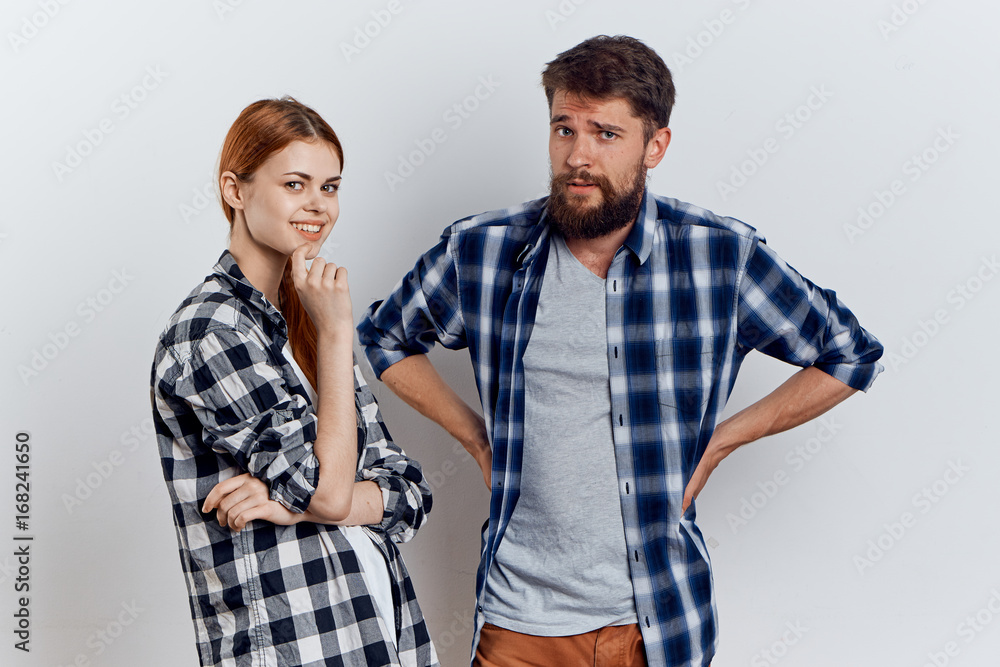 Man with a beard on a light background with a beautiful woman Man with a beard on a light background with a beautiful woman