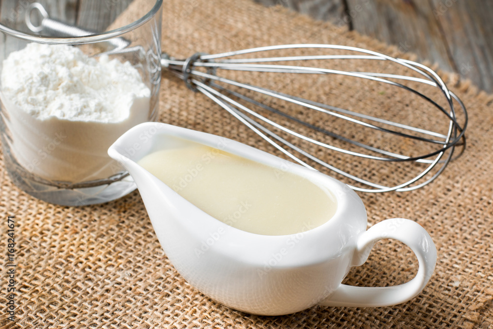 Bechamel white sauce in gravy boat Bechamel white sauce in gravy boat
