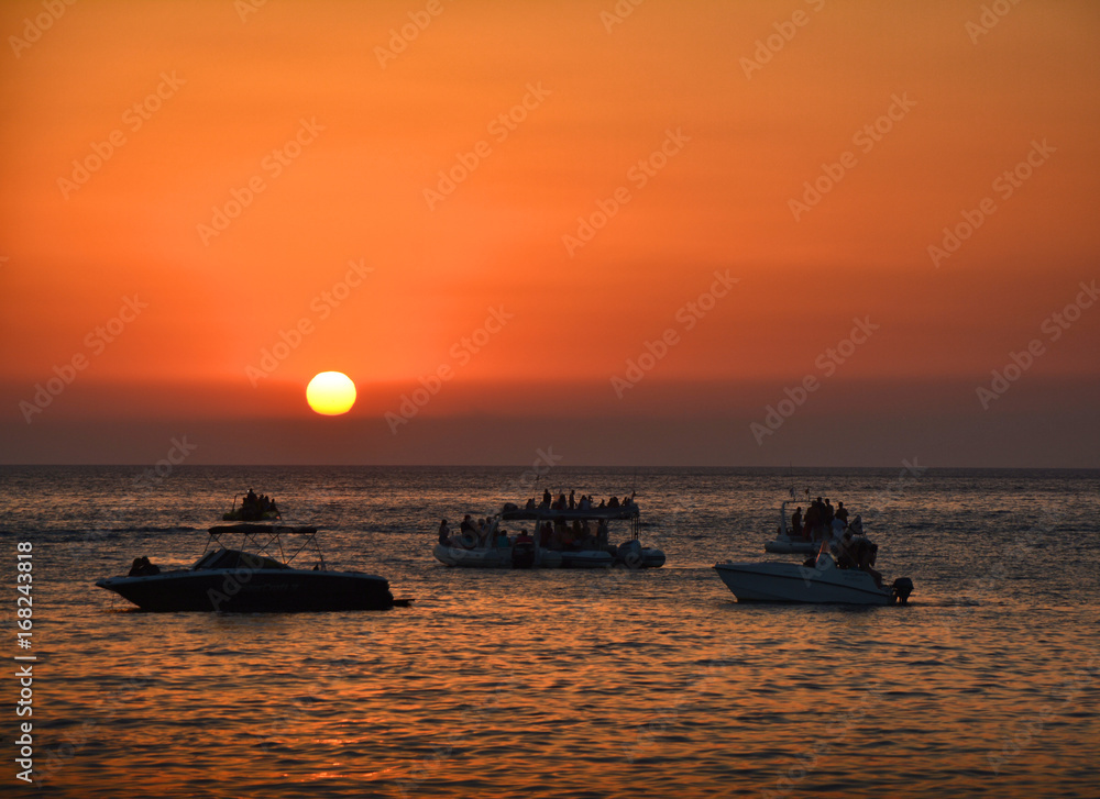 People watching sunset from boats