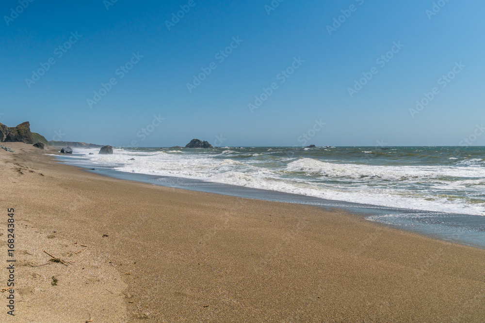 A huge sandy beach with large stones. Sonoma Coast State Park, California, USA A huge sandy beach with large stones. Sonoma Coast State Park, California, USA