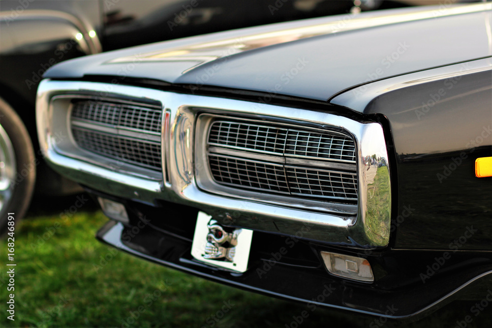 Frontal part with a grill of old black vintage car 