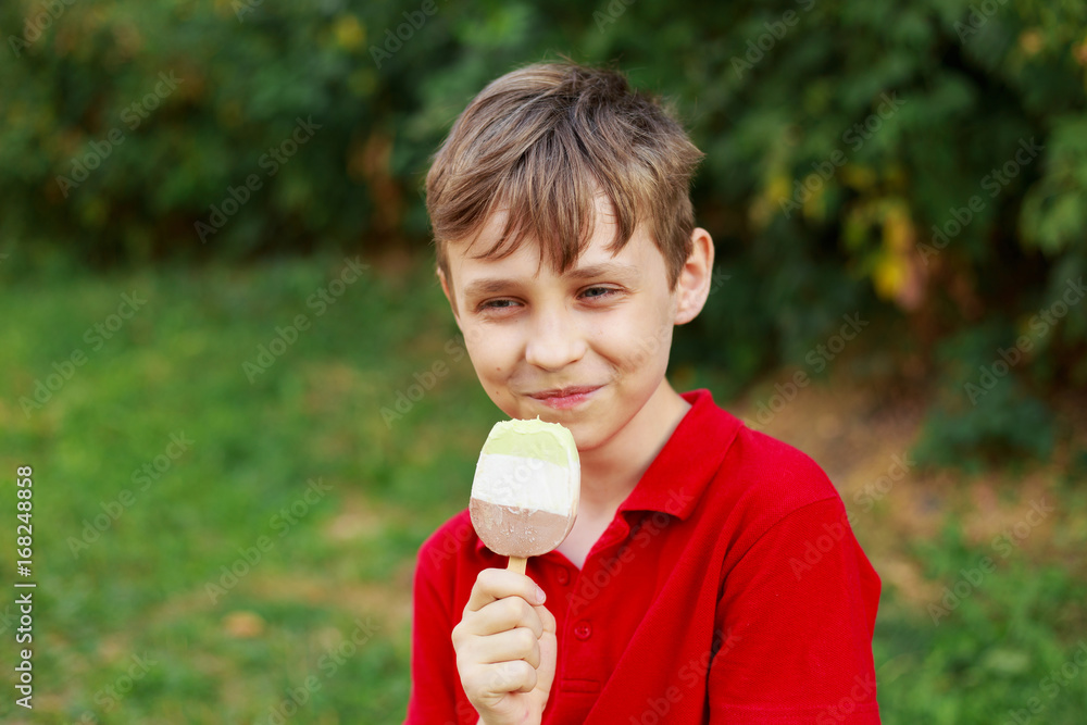 Happy smiling boy enjoy eating ice-cream. Childhood, family and people concept Happy smiling boy enjoy eating ice-cream. Childhood, family and people concept
