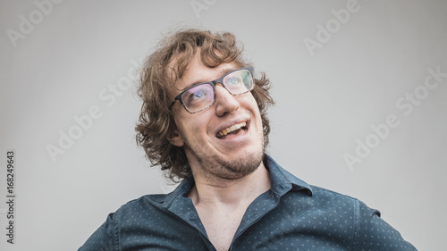 happy and proud man portrait on gray