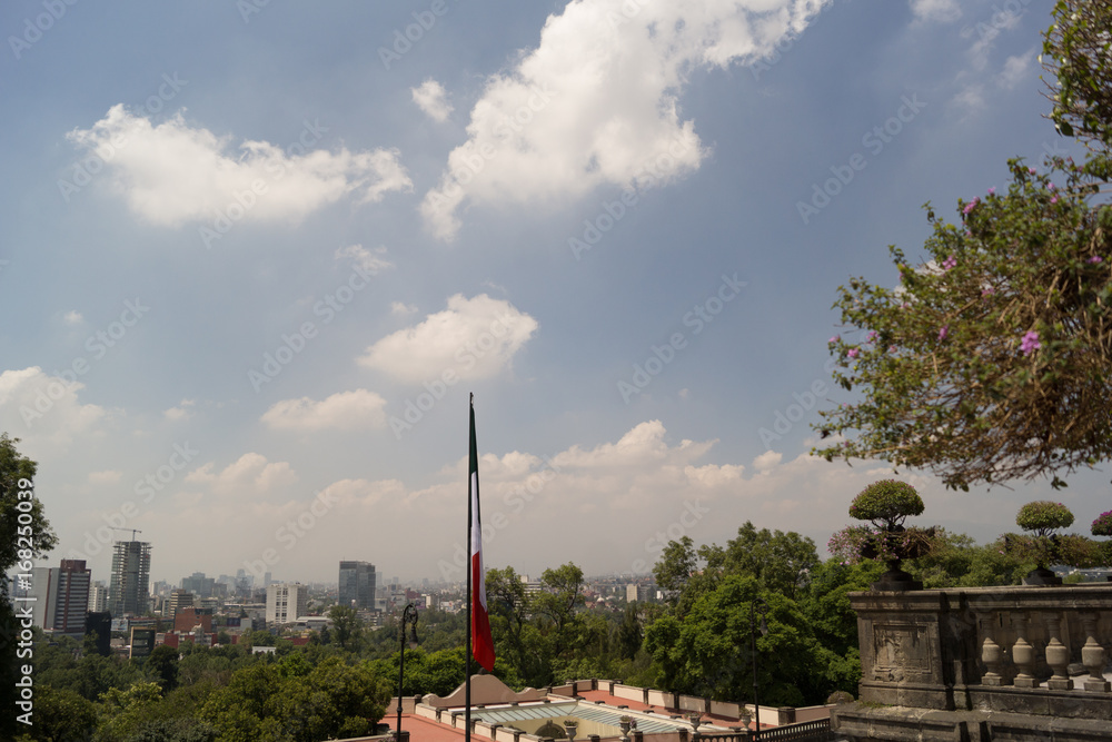 Mexico city skyline and flag in chapultepec