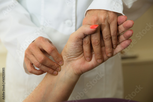 Elderly woman having her pulse taken