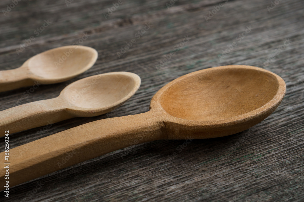 Handmade wooden spoons on a wooden board, kitchen tools Handmade wooden spoons on a wooden board, kitchen tools