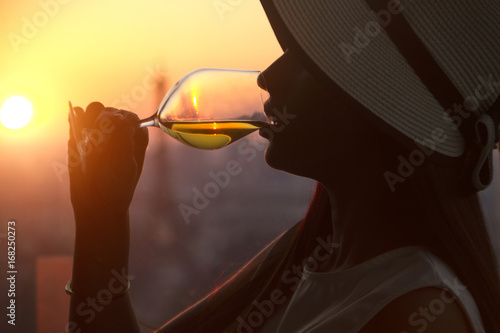Photography Girl drinking white wine at the sunset in paris city