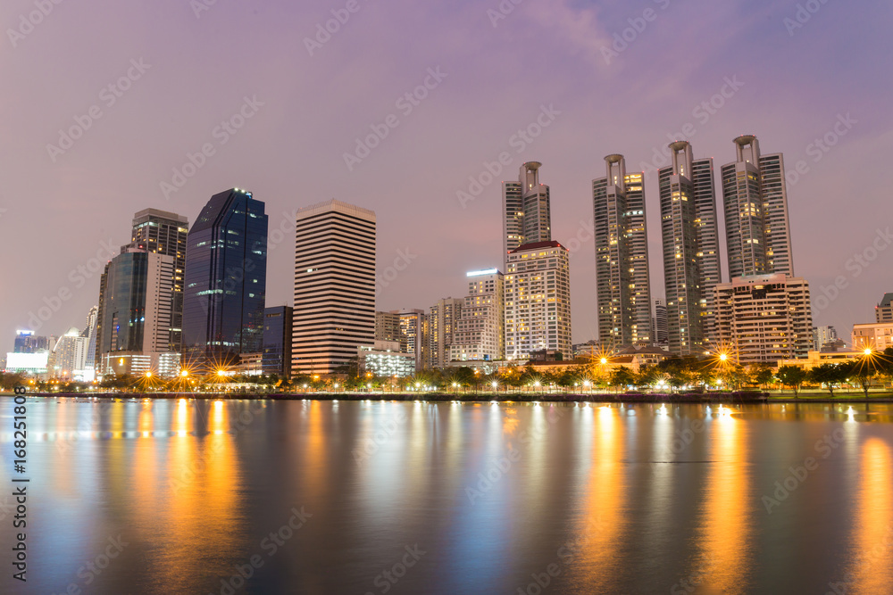 Bangkok city downtown at twilight time with reflection of skyline at Bangkok,Thailand