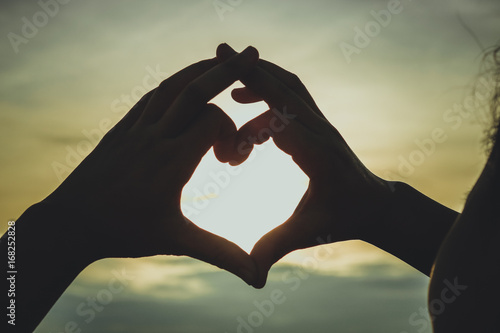 silhouette of hand in heart shape