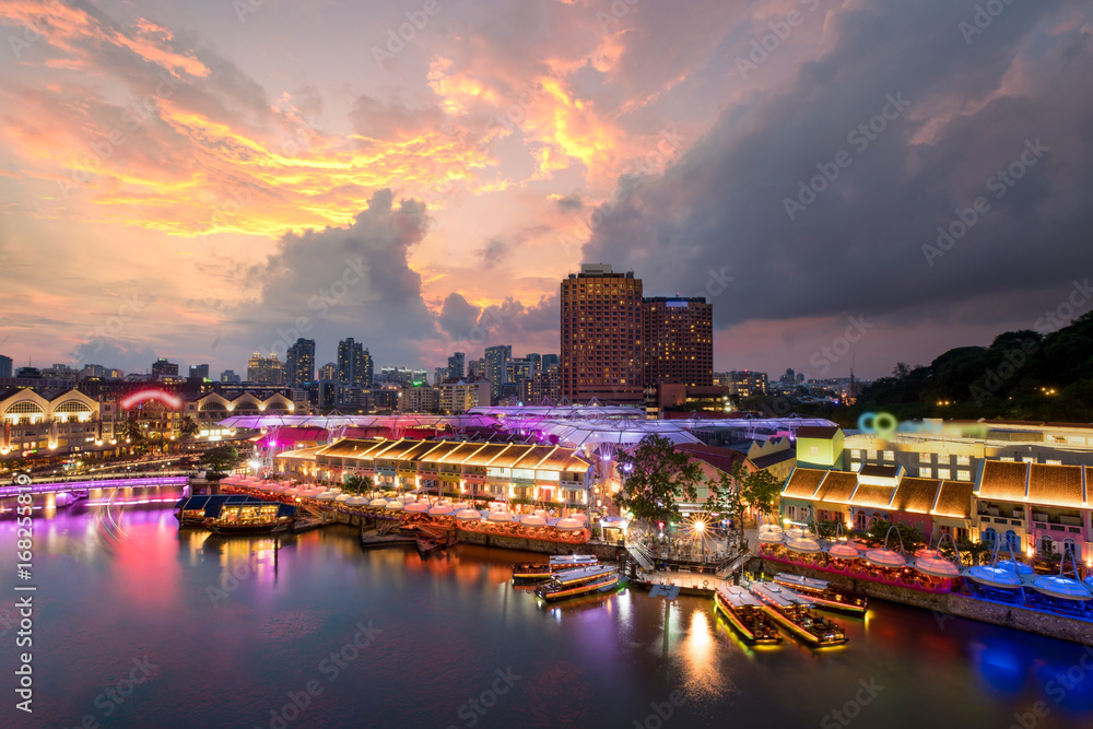 Colorful light building at night in Clarke Quay, Singapore. Clarke Quay, is a historical riverside quay in Singapore. - obrazy, fototapety, plakaty 