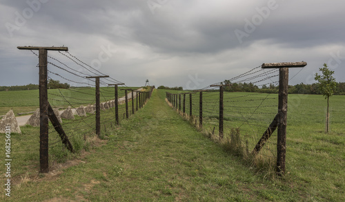 Old army road near Cizov village with roadblock and wires