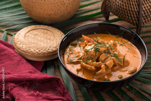 Red Curry with pork on wooden table, Thai food.