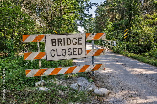 Bridge Closed Sign has been moved to the side of the road and now the bridge is both closed and open causing confusion