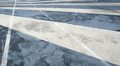 Close up asphalt road surface with white traffic strip © Artinun