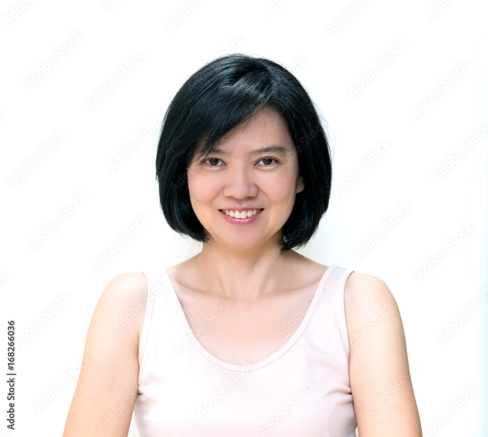 Beautiful smiling Asian women with clean skin, natural make-up, short black hair and white teeth isolated on white background. Middle aged woman wearing beige dress, image for skin and healthy concept Beautiful smiling Asian women with clean skin, natural make-up, short black hair and white teeth isolated on white background. Middle aged woman wearing beige dress, image for skin and healthy concept
