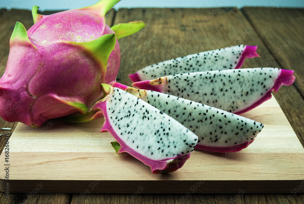 Dragon fruit on old wood board Dragon fruit on old wood board