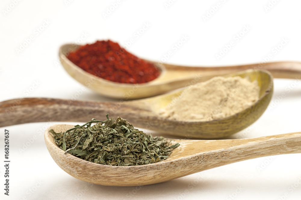 Close up of basil leaves in wooden spoon. Close up of basil leaves in wooden spoon.