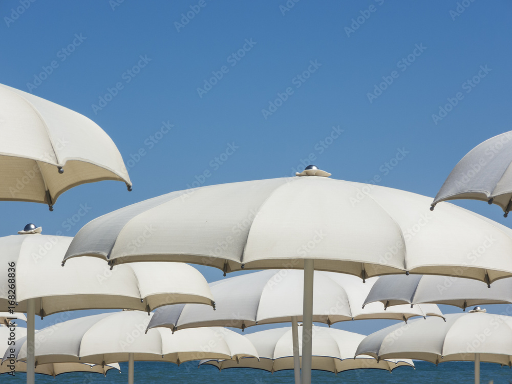 Umbrellas and gazebos on Italian sandy beaches. Adriatic coast. Emilia Romagna region