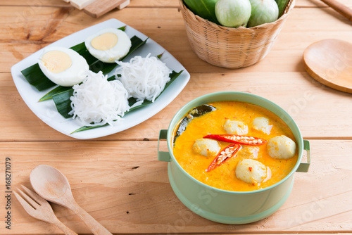 Coconut milk Curry fish and fish ball with thai rice noodle photo