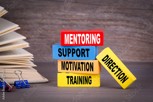 Mentoring concept. Colored wooden blocks on the table.