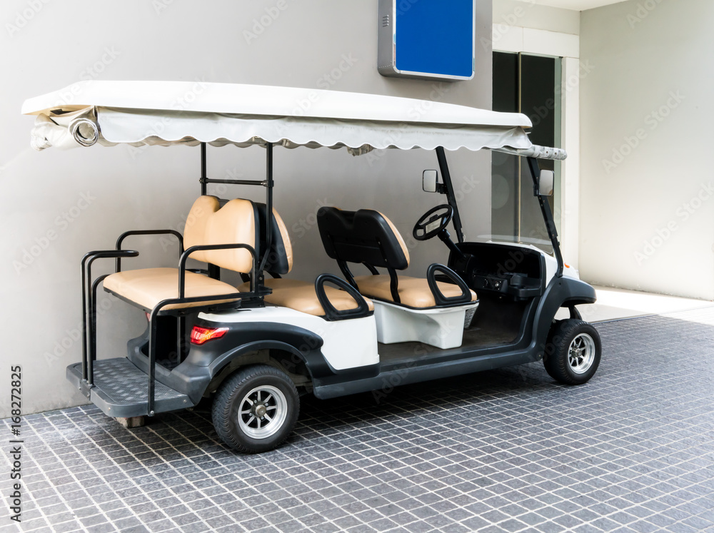 White golf cart with back seats in the public building