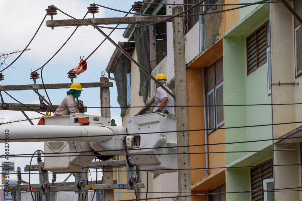 The electrician went up to the crane basket