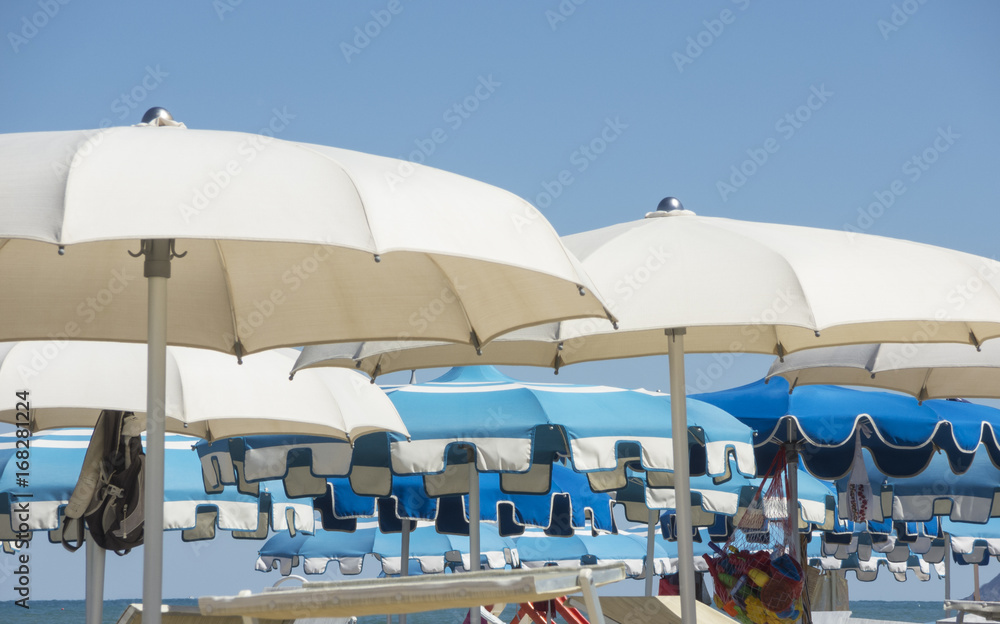 Umbrellas and gazebos on Italian sandy beaches. Adriatic coast. Emilia Romagna region