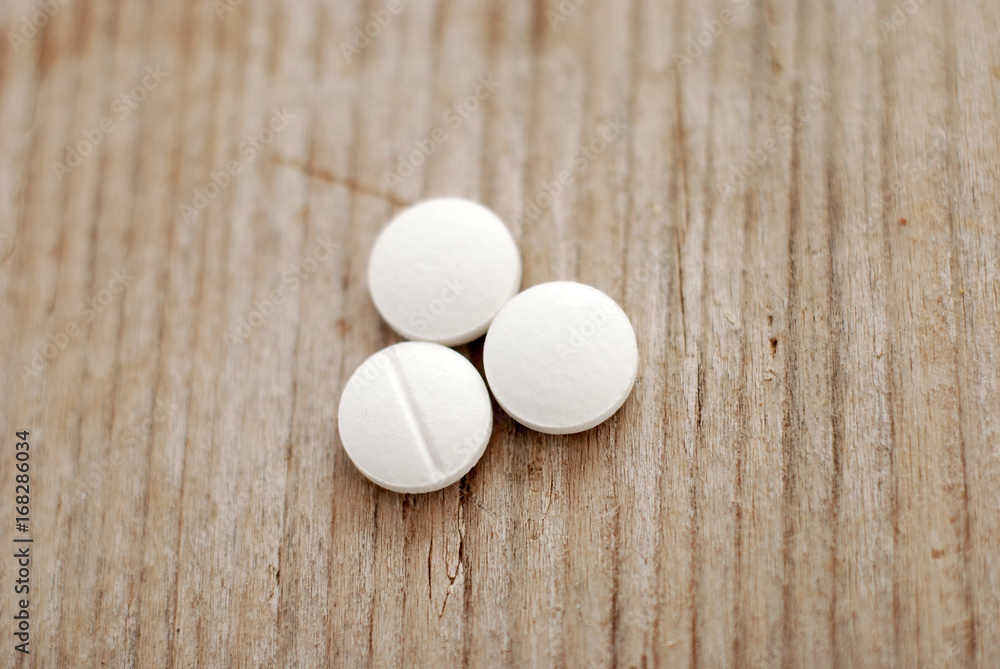 Pills on wood background,top view Pills on wood background,top view