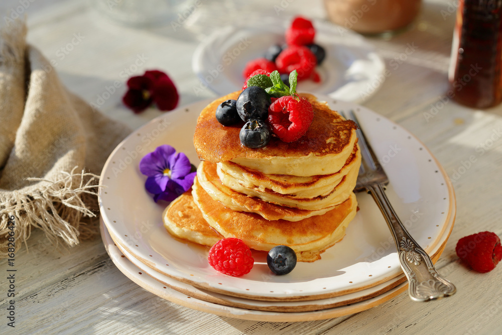 Golden pancakes with berry and honey Golden pancakes with berry and honey