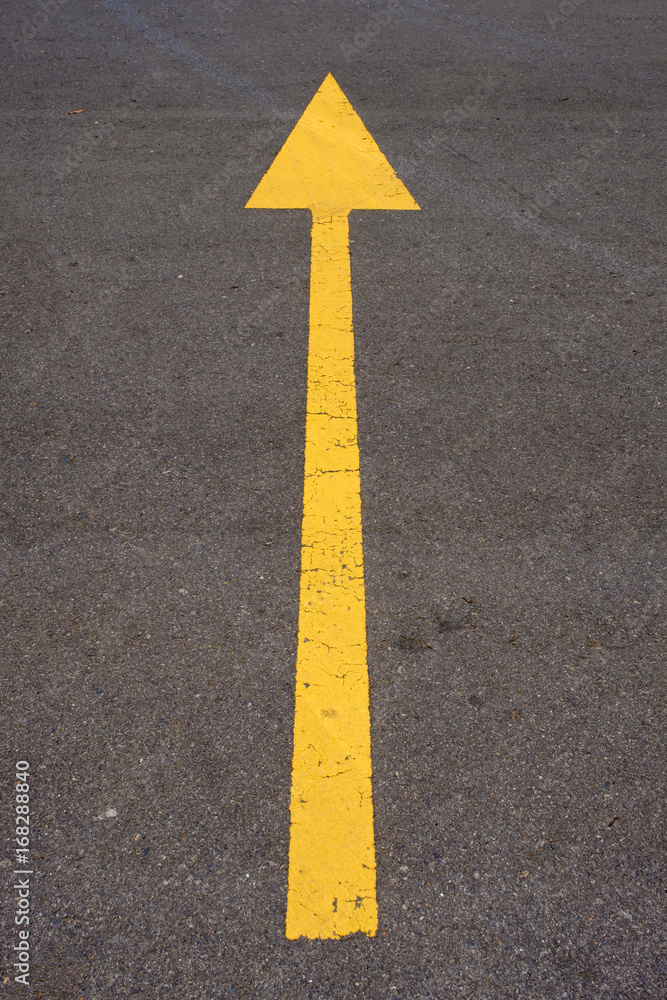 The yellow arrow on the road background