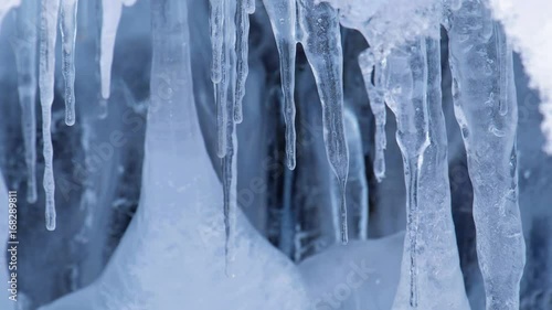 Video of ice, icicles and gurling water in cave on Altai river Bolshaya Gromotuha in winter season photo