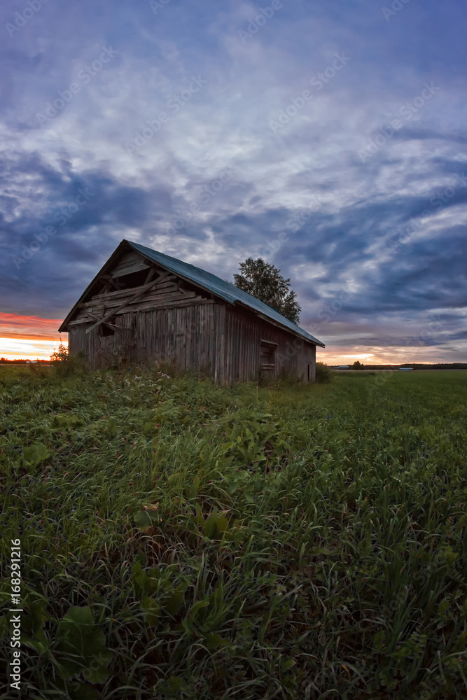 Sunset Clouds And An Old Barn House