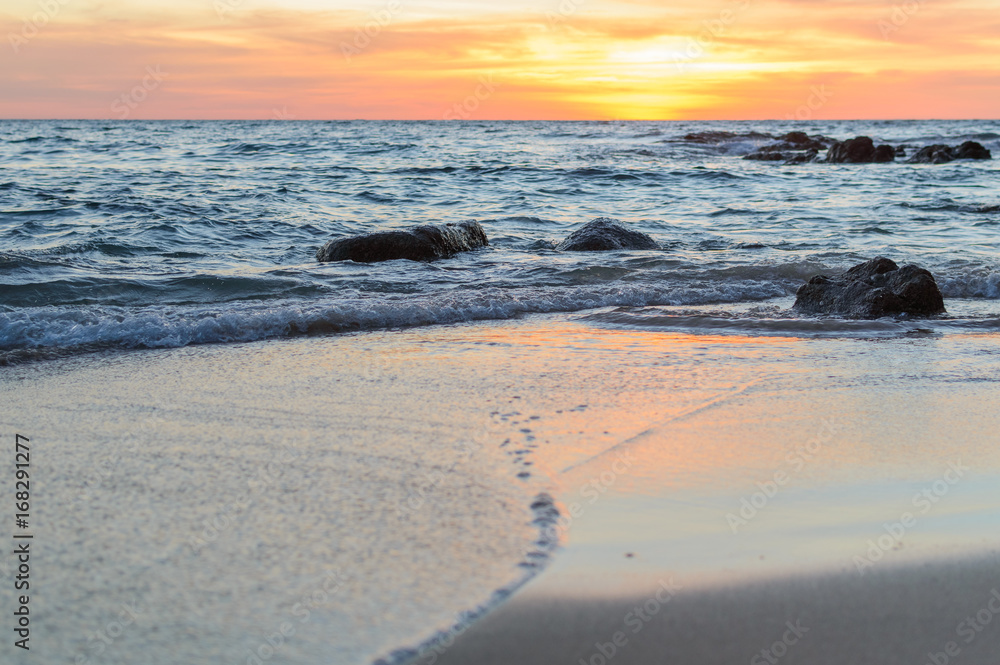 Sunrise or Sunset over the sea view from tropical beach with orange sky