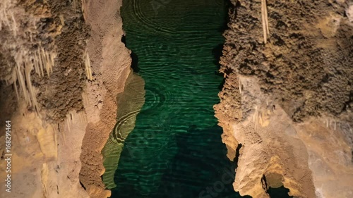 Underground lake sorrunded by rocks photo