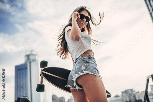 Female teenager with skateboard