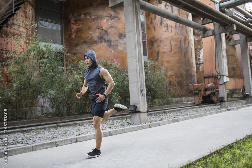 Young man jogging outdoors Young man jogging outdoors