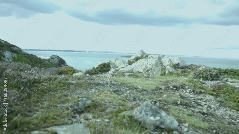 Low Prospective of a Man Hiking in Howth Tracking. Ireland Landscape Low Prospective of a Man Hiking in Howth Tracking. Ireland Landscape