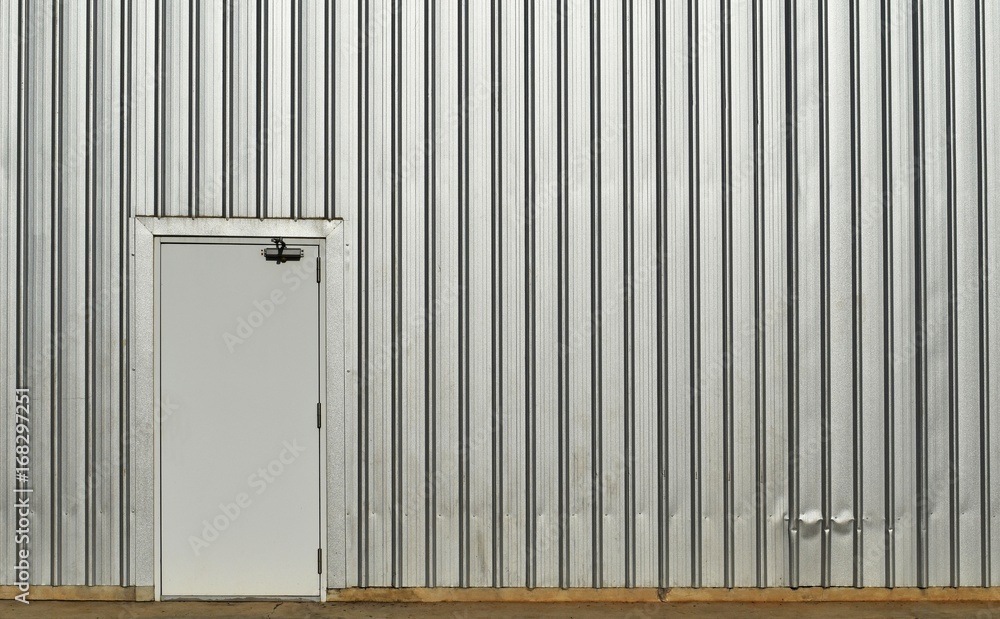 white door in old and dirty metal wall on dirty concrete for background white door in old and dirty metal wall on dirty concrete for background