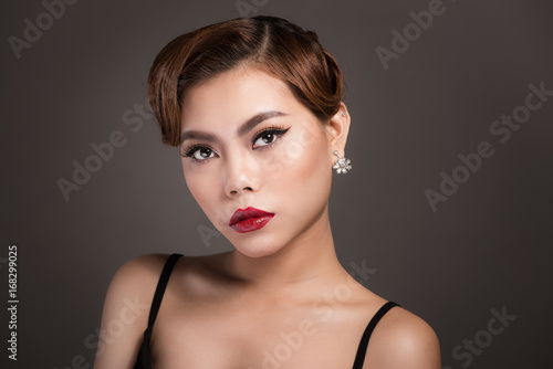 Portrait of beautiful sensual asian woman with elegant hairstyle and perfect makeup.
