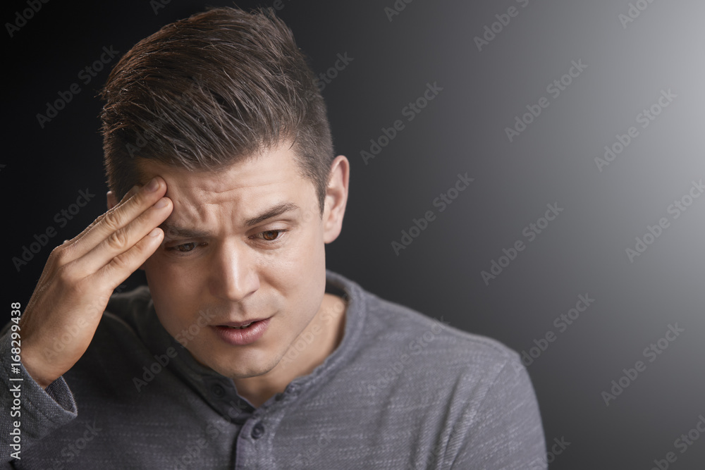 Portrait of a worried young white man looking down Portrait of a worried young white man looking down