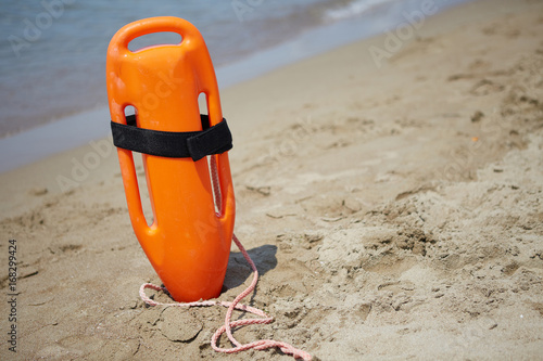Rescue buoy on the background of the beach and the sea.