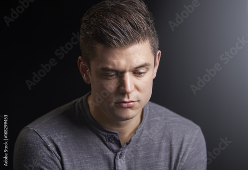 Portrait of a worried young man looking down