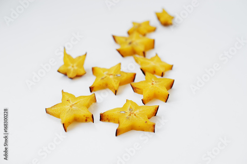 Close-up photo of star fruit or carambola slices on the white background.