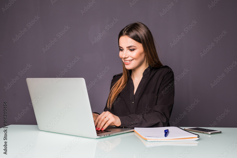 Portrait of a happy casual businesswoman in sweater sitting at her workplace in office Portrait of a happy casual businesswoman in sweater sitting at her workplace in office