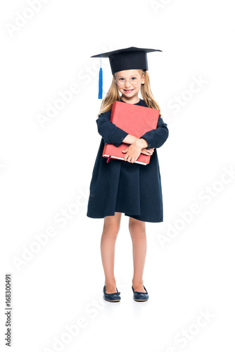 schoolgirl in graduation hat with big book